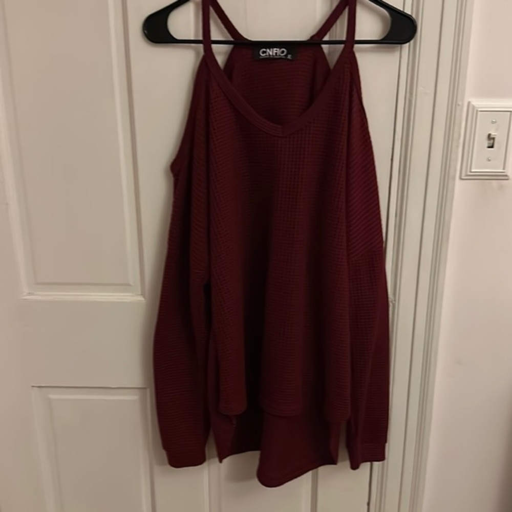 Woman’s shoulder less sweater